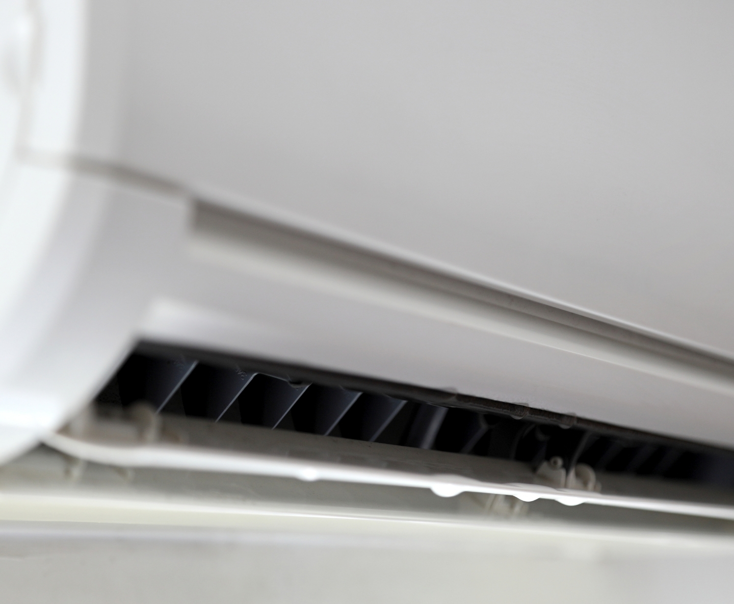 Close-up of an air conditioner vent grille with horizontal slats.